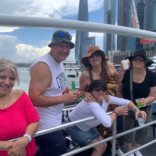 a group of people standing next to a fence