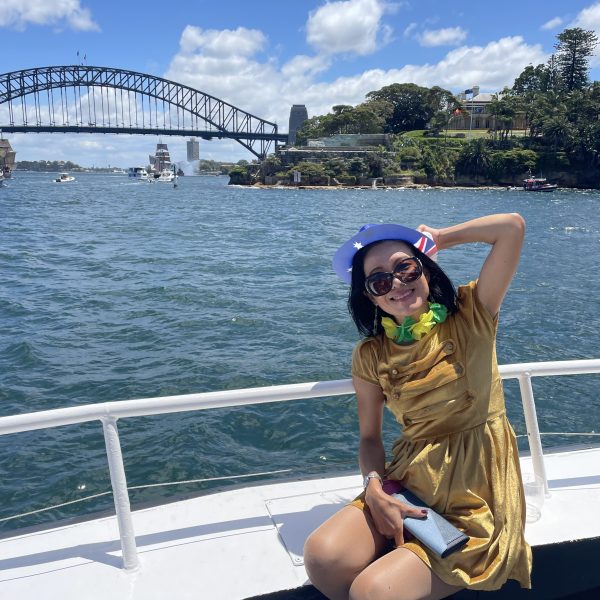 a woman standing next to a body of water