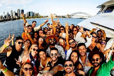 a group of people posing in front of a body of water