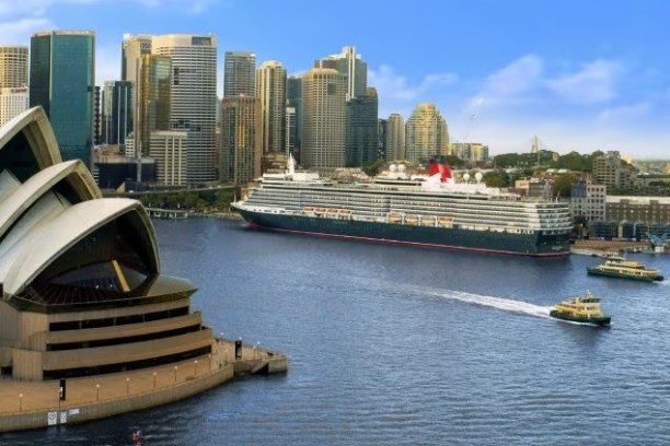 a small boat in a body of water with a city in the background