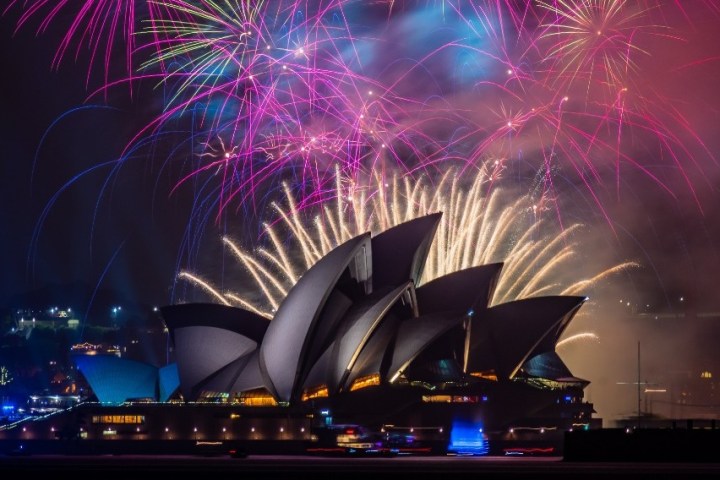 Colorful fireworks over the Sydney Opera House at night.